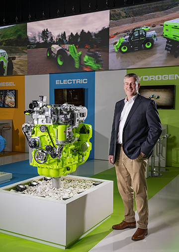 JCB Chief Innovation and Growth Officer Tim Burnhope with the JCB hydrogen engine at Conexpo